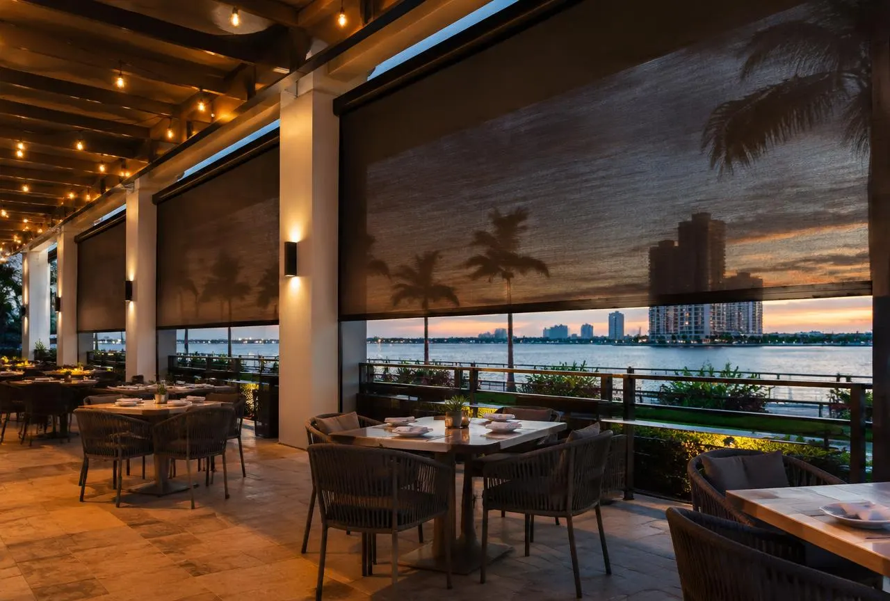 Restaurant patio with large motorized screens lowered between columns